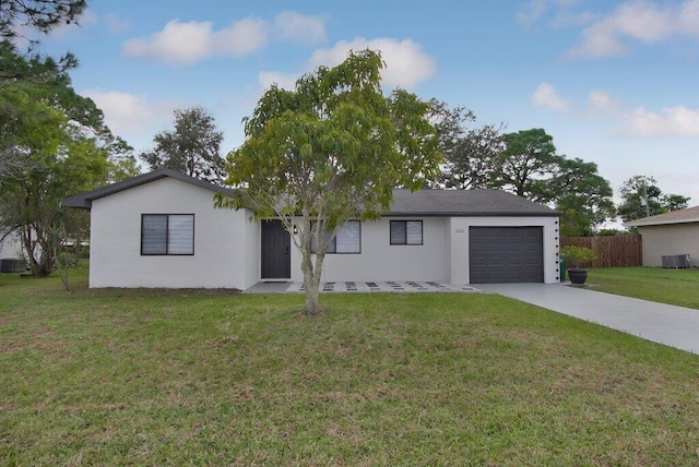 ranch-style house with cooling unit, a garage, and a front lawn