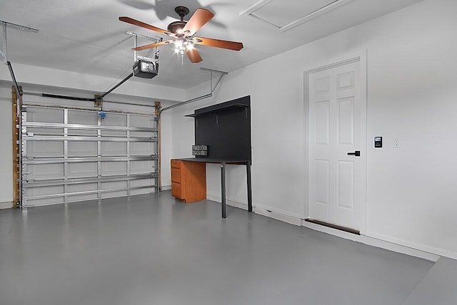 garage featuring baseboards, a ceiling fan, and a garage door opener