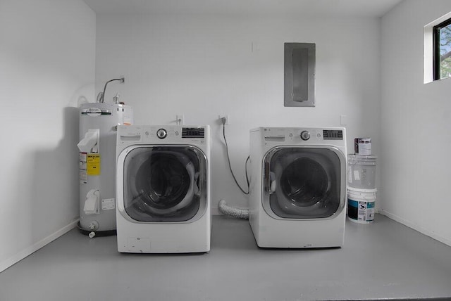 washroom featuring laundry area, electric panel, baseboards, independent washer and dryer, and electric water heater