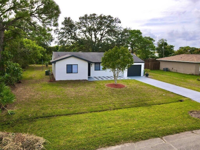 ranch-style home with central AC unit, an attached garage, driveway, stucco siding, and a front lawn