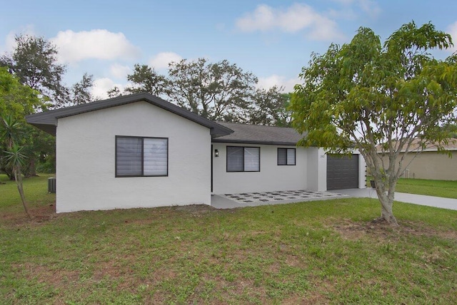 ranch-style home featuring a garage, a front lawn, concrete driveway, and stucco siding