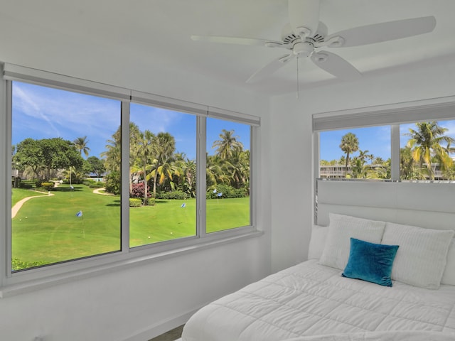 bedroom with multiple windows and ceiling fan