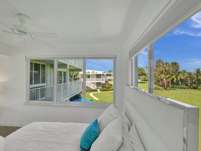 bedroom featuring multiple windows, wood-type flooring, and ceiling fan