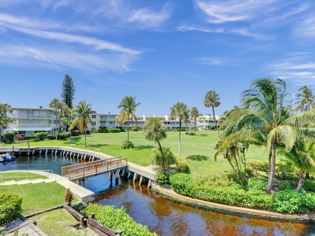 view of home's community featuring a yard and a water view