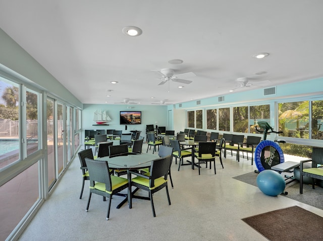 sunroom / solarium with ceiling fan and plenty of natural light