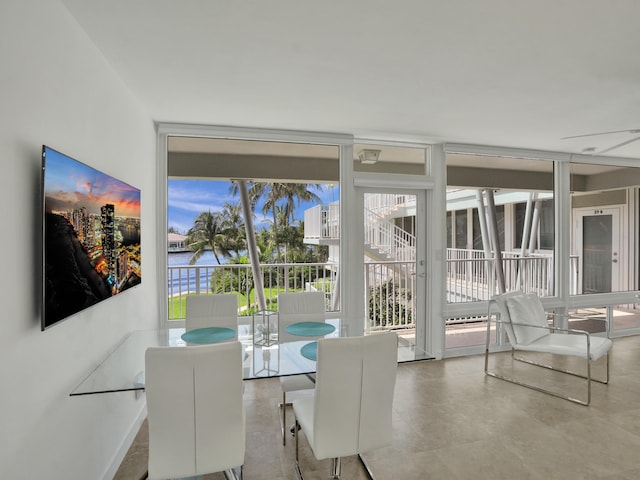 dining room featuring a wealth of natural light and a wall of windows