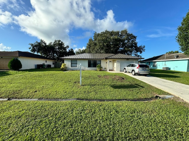 single story home with cooling unit, a garage, and a front lawn