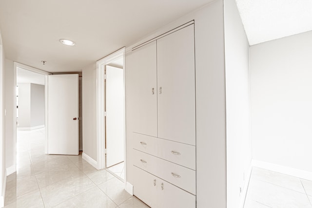 hall with light tile patterned flooring