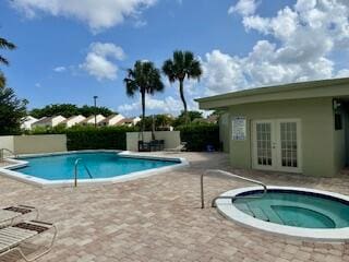 view of swimming pool with a patio area and an in ground hot tub