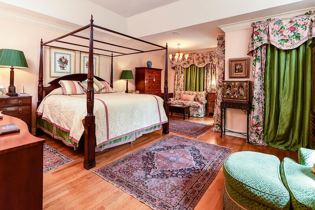 bedroom featuring an inviting chandelier and hardwood / wood-style flooring