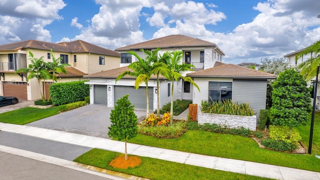 mediterranean / spanish home with a garage and a front yard