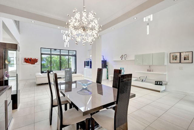 dining area with a notable chandelier, light tile patterned flooring, crown molding, and a high ceiling