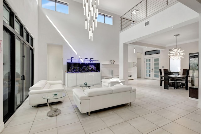 living room featuring light tile patterned floors, crown molding, a high ceiling, and french doors