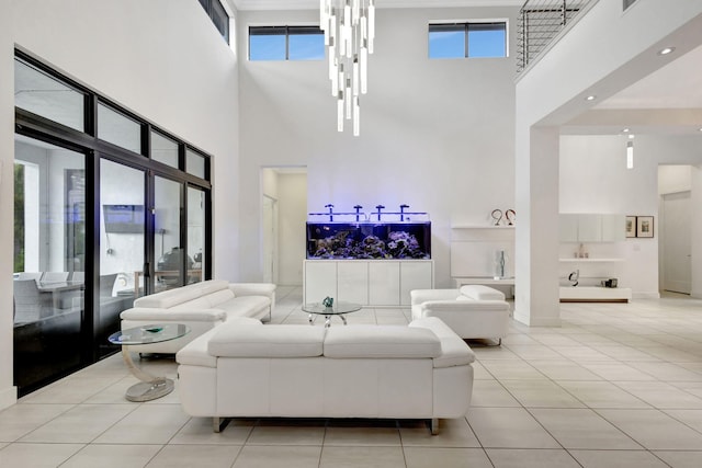 living room featuring a high ceiling, light tile patterned floors, and plenty of natural light