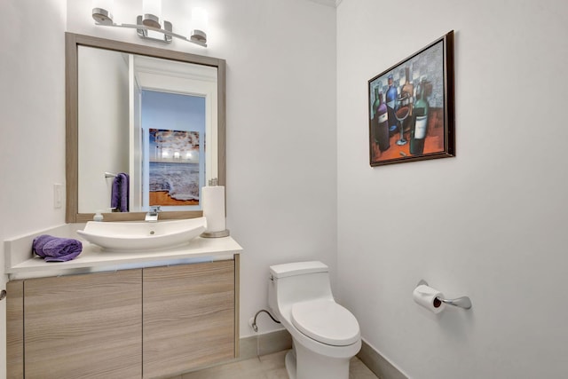 bathroom with tile patterned flooring, vanity, and toilet