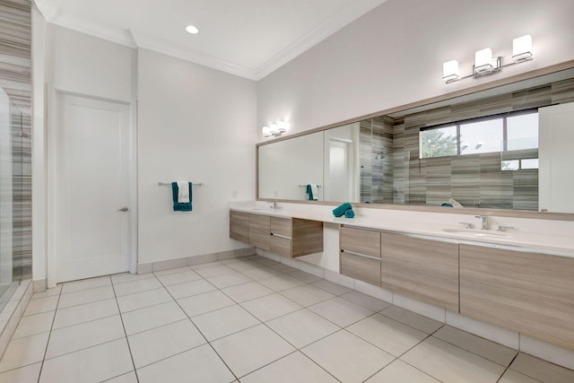 bathroom with tile patterned flooring, vanity, crown molding, and tiled shower