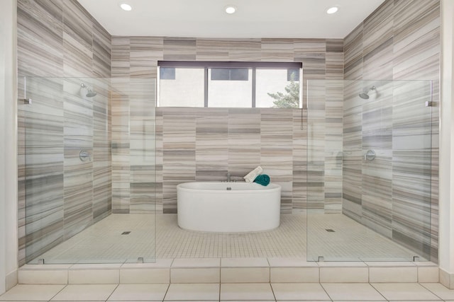 bathroom featuring tile patterned flooring, independent shower and bath, and tile walls