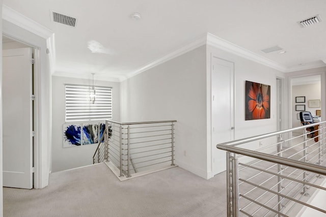 hall featuring light carpet, an inviting chandelier, and crown molding