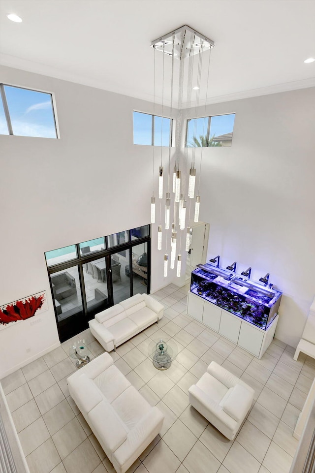 interior space with crown molding and light tile patterned flooring