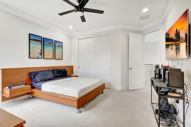 bedroom with light carpet, a closet, ceiling fan, and crown molding