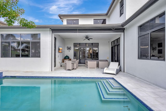 view of pool with outdoor lounge area, ceiling fan, and a patio