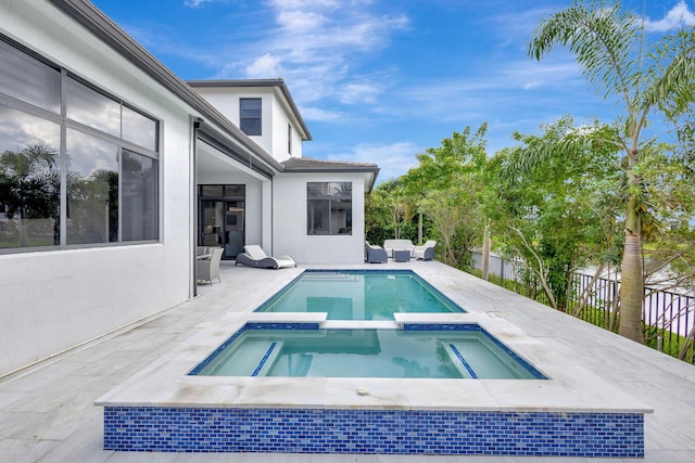 view of pool with a patio area and an in ground hot tub