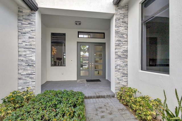 view of exterior entry featuring french doors