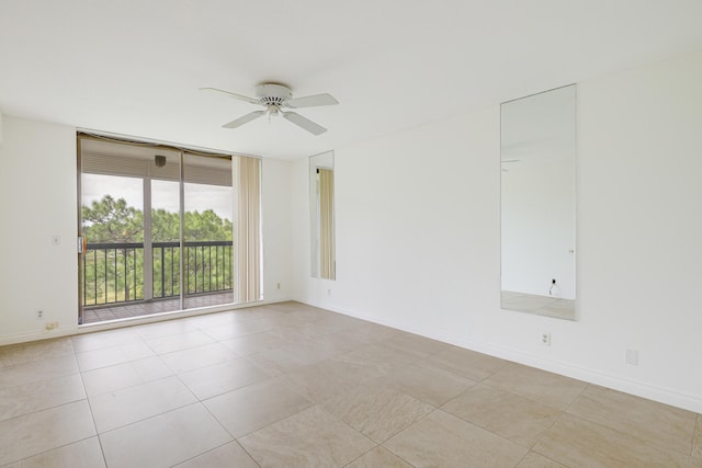 spare room with light tile patterned floors and ceiling fan