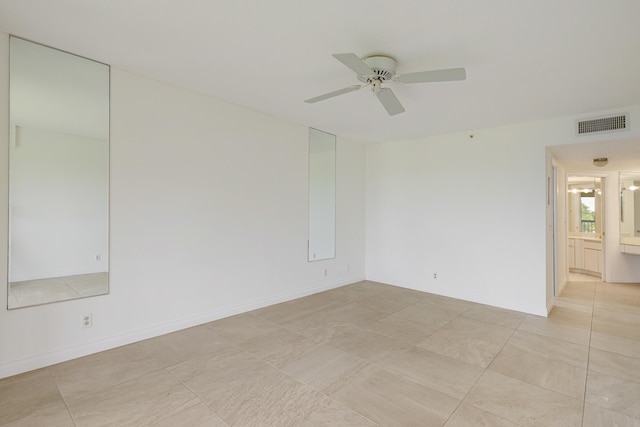 tiled spare room with ceiling fan