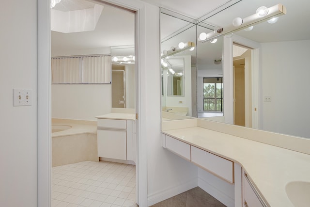 bathroom featuring vanity, a tub to relax in, and tile patterned flooring