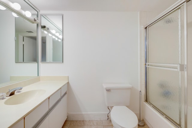 full bathroom with vanity, combined bath / shower with glass door, toilet, and tile patterned floors