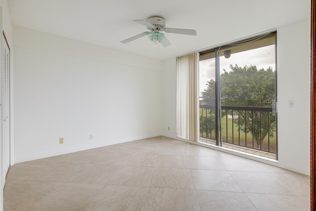 tiled empty room with ceiling fan