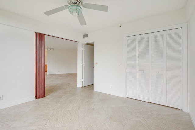 unfurnished bedroom with a closet and ceiling fan