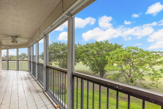 unfurnished sunroom with ceiling fan