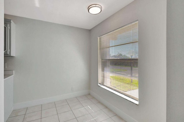 spare room featuring light tile patterned flooring