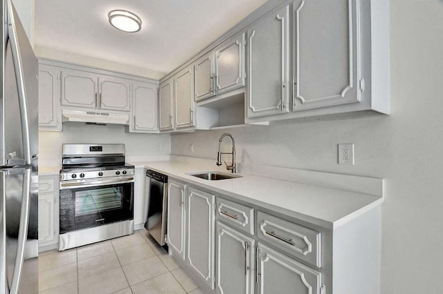 kitchen with sink, appliances with stainless steel finishes, gray cabinetry, and light tile patterned flooring