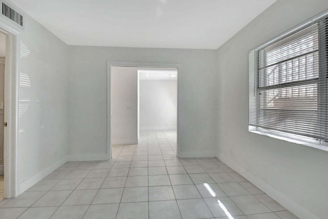 unfurnished room featuring light tile patterned flooring