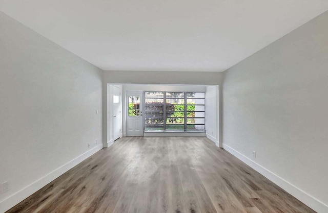 unfurnished room featuring hardwood / wood-style flooring