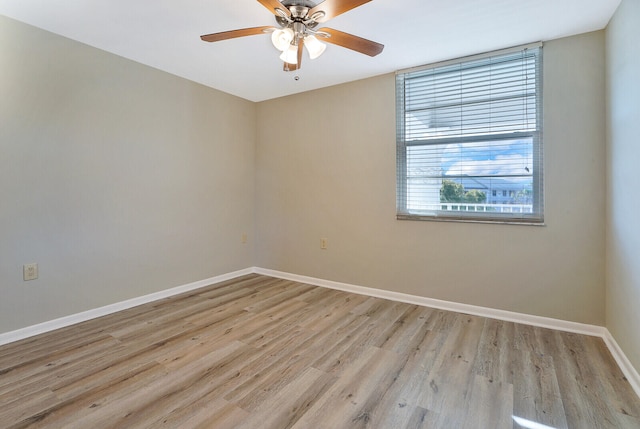 empty room featuring light wood-type flooring and ceiling fan