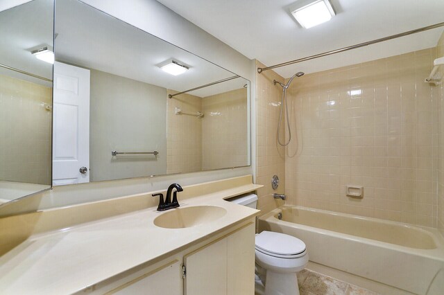 full bathroom featuring vanity, toilet, tile patterned floors, and tiled shower / bath