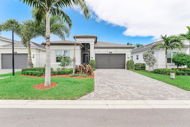 view of front of property featuring a front lawn and a garage