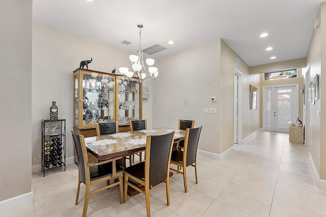 dining room featuring a chandelier, light tile patterned flooring, and french doors