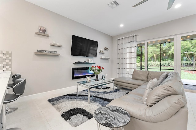 living room featuring ceiling fan and light tile patterned flooring