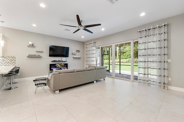 tiled living room featuring ceiling fan