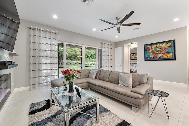 living room with ceiling fan and light tile patterned floors