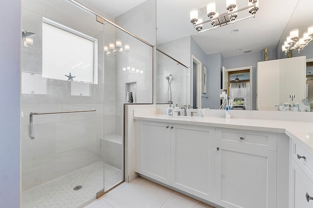 bathroom featuring vanity, an enclosed shower, plenty of natural light, and tile patterned flooring