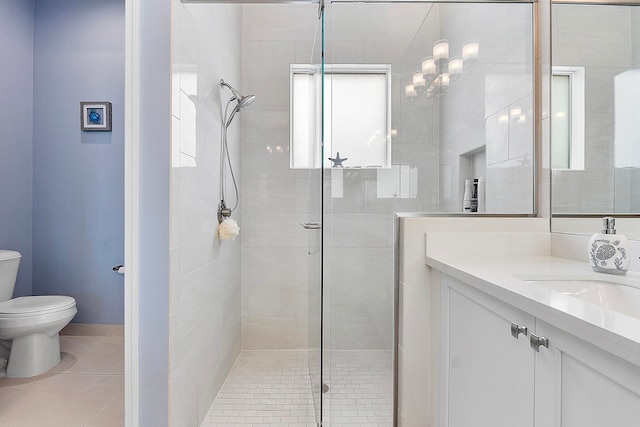 bathroom featuring vanity, toilet, walk in shower, and tile patterned flooring