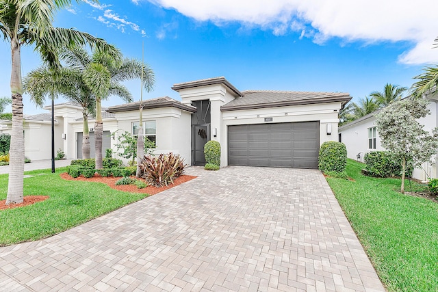 view of front of property featuring a front yard and a garage