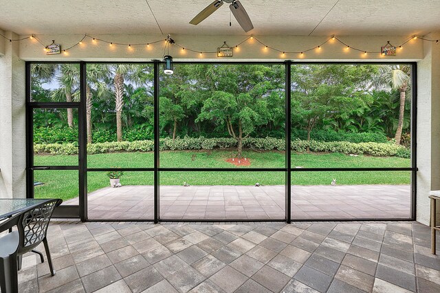 doorway to outside featuring ceiling fan