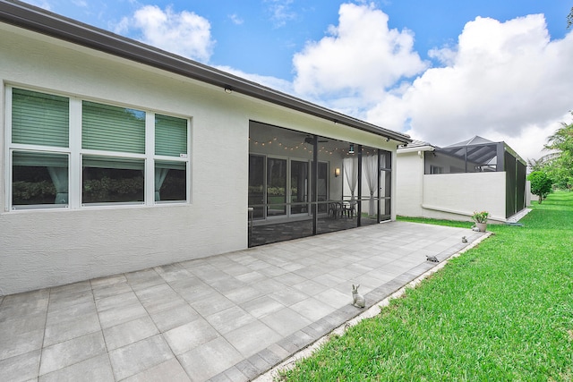 view of patio / terrace featuring glass enclosure